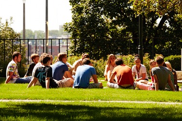 Group of students sitting in a circle outside