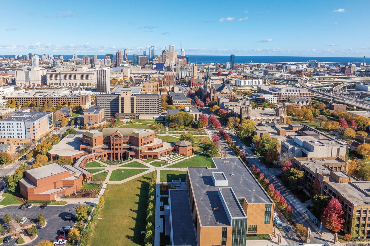 Campus drone shot with beautiful green space new buildings and view of Lake Michigan