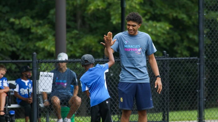 Two young men giving each other a high five