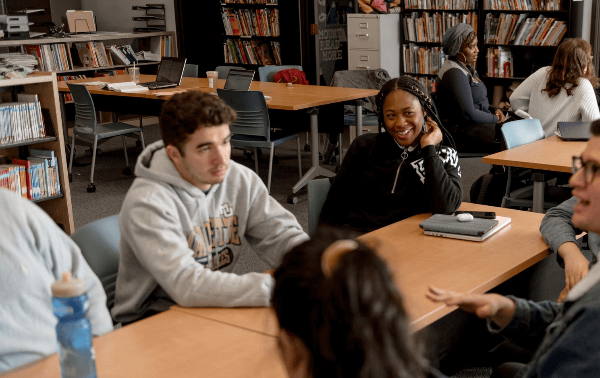 Students talking around a table