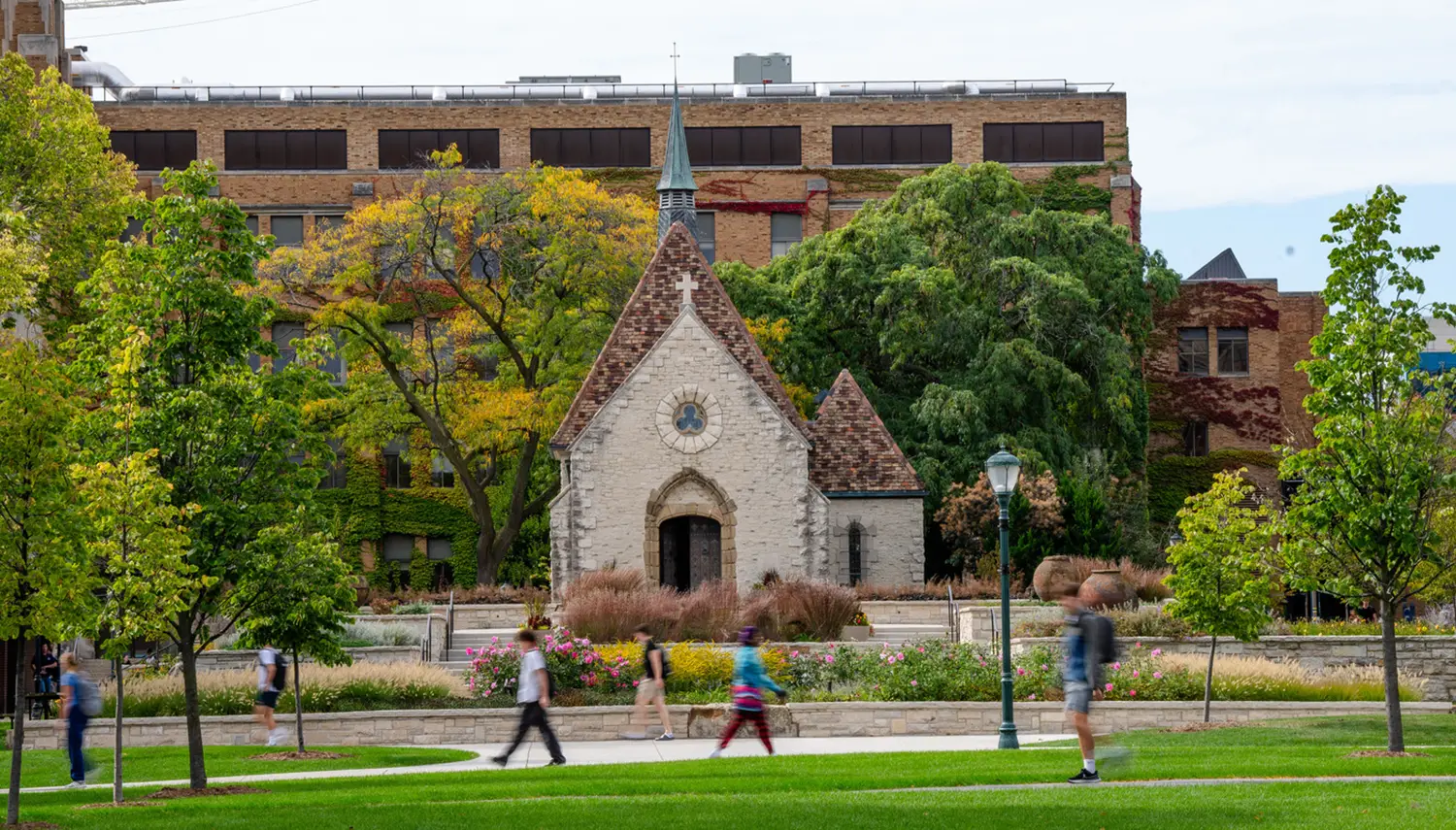 students walk around marquette's green spaces