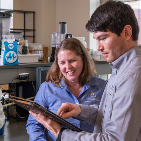 faculty member discussing work with graduate student