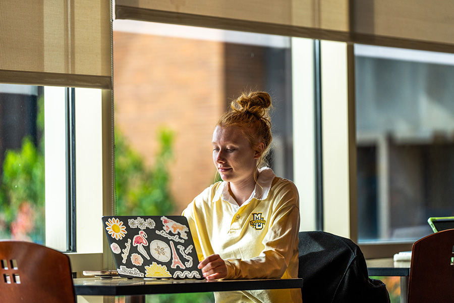 A student studying on the Marquette University campus