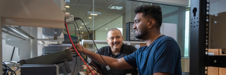 faculty member advising graduate student during electrical engineering project