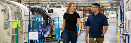 two professionals walking in factory