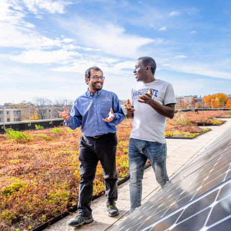 Dr. Somesh Roy and student talking on green roof