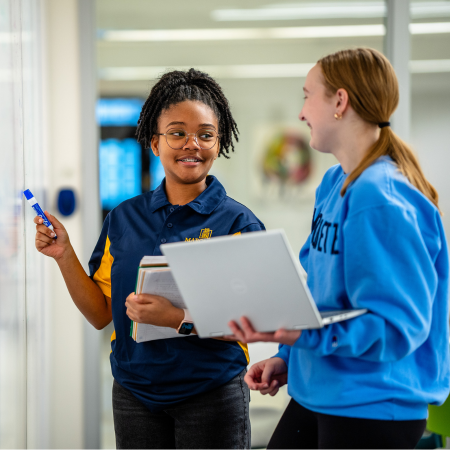 two students at whiteboard