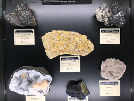 several mineral specimens in a glass exhibition case