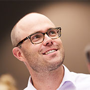 Man in glasses looking up. 