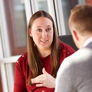 A woman and a man having a conversation. 