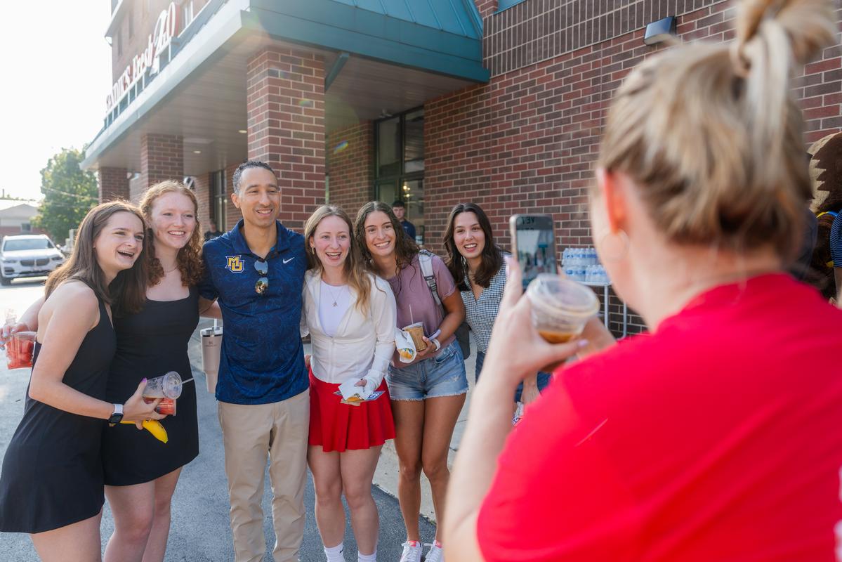 Coach Smart posing with students on the first day of classes, 2023