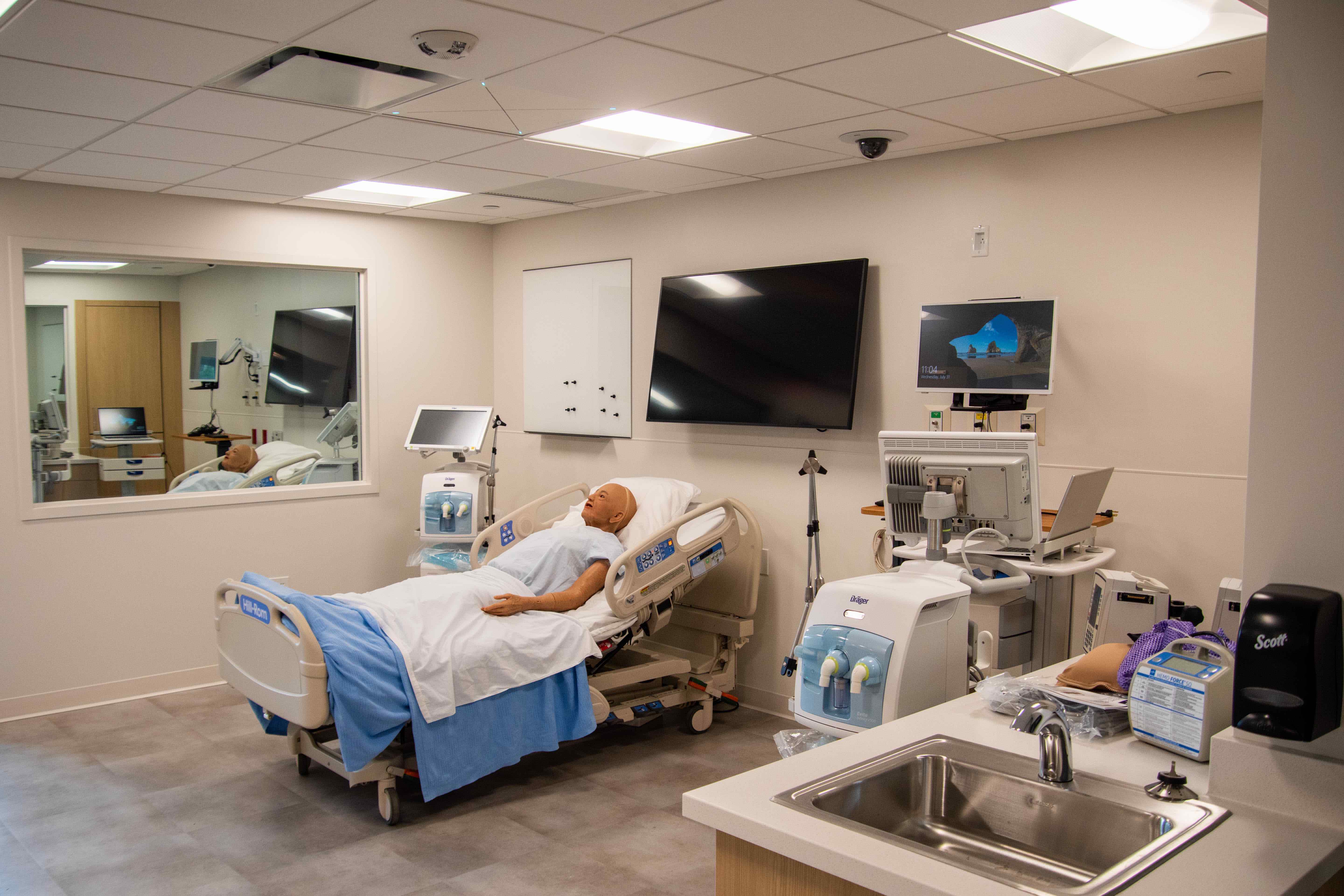 A mannequin in a simulation center room.