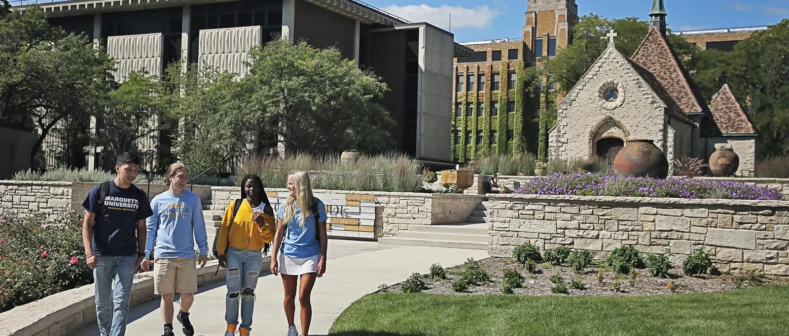 marquette students walking near joan of arch chapel